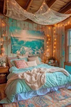 a bedroom with string lights hanging from the ceiling and a bed covered in blue blankets