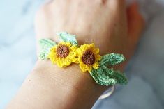 handmade micro crochet sunflower bangle 14K gold plated adjustable bangle with a miniature crochet flower.  These bangles are made with a DMC cordonnet. They are lightweight and perfect for all-day wear. bangle is gold-plated brass from Korea. If you have any questions, please reach out to us via messages before purchasing. *All items are handmade and may contain minor imperfections & and a little color difference and variation between the picture and the actual item. But it doesn't make a big difference overall. Since this is a handmade item, we recommend handling these pieces with care. Do not bend or set heavy items on top of the bangle.  ORDER  This item is made to order. Once the order is placed, I need 7 business days to prepare and ship the item. thank you! Wedding Wrist Corsage, Flower Cuff Bracelet, Flower Cuff, Micro Crochet, Miniature Crochet, Minimalist Flower, Crochet Sunflower, Minimalist Flowers, Gift Flower