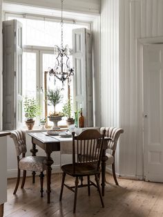 a dining room table with chairs and a chandelier