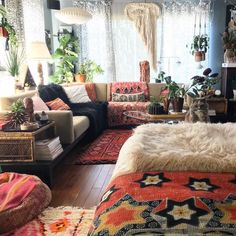 a living room filled with lots of furniture and plants