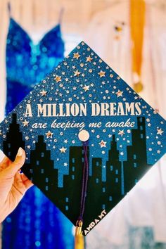 a person holding up a graduation cap that says, a million dreams are being awarded