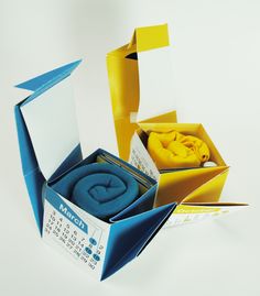 an open box with a blue blanket inside and calendar in the bottom right hand corner