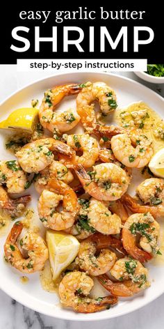 a white plate topped with shrimp and lemons on top of a marble countertop