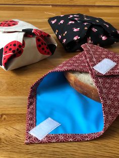 three bags with ladybugs on them sitting on a table next to each other