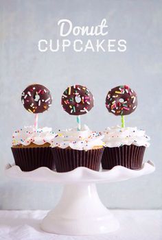 three chocolate cupcakes with white frosting and sprinkles on top