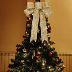 a decorated christmas tree with a bow on top