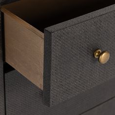 a close up of a drawer with two brass knobs on the bottom and an open drawer