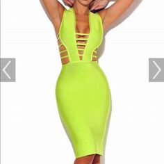 a woman wearing a neon green dress with cutouts on the back and sides, standing in front of a white background