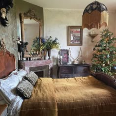 a bedroom with a bed, mirror and christmas tree