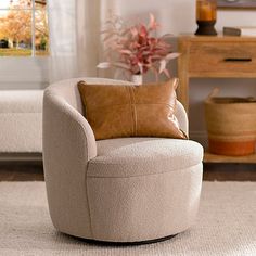 a living room with a chair, table and potted plant