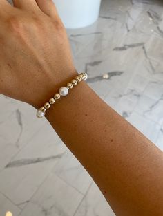 This 7mm gold ball and 8mm freshwater pearl bracelet is perfect for any stack and goes with any outfit! Pair with all gold ball collection bracelets for a perfect stacked look!