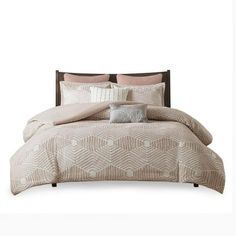 an image of a bed set with pillows and comforter in beige color on white background