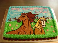 a birthday cake with two horses on it