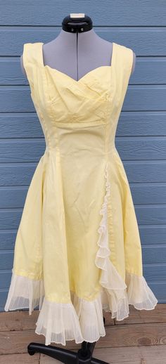 1950s handmade yellow a-line dress with ruffle down the front and on the skirt bottom. It has a shelf bra and metal zipper.  No size and no company Measurements Length 40.5 inches chest 36 inches waist  26 inches Yellow Dresses With Ruffles And Fitted Bodice, Yellow Vintage Dress 1950s Style For Spring, Yellow Vintage Dress, 1950s Style For Spring, 1950s Style Yellow Vintage Dress For Spring, 1950s Style Vintage Yellow Dress For Spring, Yellow Fitted Dress In 1950s Style, Fitted Yellow Dress In 1950s Style, Yellow 1950s Style Dress For Vintage Fashion, Retro A-line Vintage Dress With Ruffles