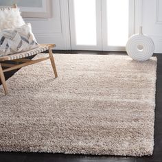 a white rug with a chair in front of it