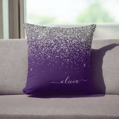 a purple pillow with silver glitter on it