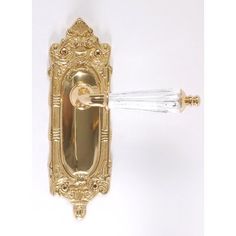 an ornate gold door handle with glass knobs on the front and back of it