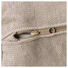 an open zipper on a beige jacket