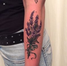 a woman with a tattoo on her arm has lavenders and butterflies tattooed on her arm