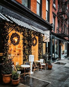 an empty sidewalk with chairs and tables on it