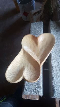 a wooden bowl sitting on top of a table