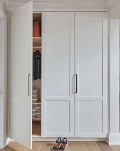 a pair of shoes sitting on the floor in front of a white closet with sliding doors