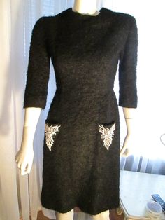 "Too Cute high neckline with back skirt kick pleat, quarter length sleeves, two 5\" \"V\" shaped pockets on the front of this curly wool mohair dress, that are decorated with small white and brown beads. The dress is silk lined and is in great condition. Waist is 25\", Hip is 34\", Bust is 34\", Shoulder 15 1/2\" across, Skirt length 23\". The back zipper is nylon. Possible fit, 5/6 to maybe 7/8. Great condition, possible 1960's, but no label name. PRICE IS$95.00SALE FINAL/AS IS/NO RETURNS." Mohair Dress, Label Name, Womens Black Pants, Back Skirt, Kick Pleat, Stunning Outfits, Skirt Fits, Lovely Dresses, Pocket Dress