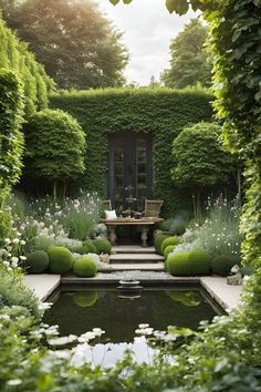 a small pond surrounded by greenery in the middle of a garden with chairs and tables