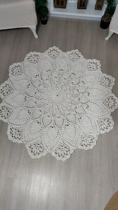 a large white doily is on the floor