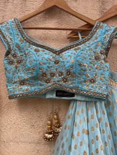 A three-piece powder blue sharmily zari lehenga set from the Priti Sahni collection. This georgette powder blue butti lehenga with pearl-zari work border detail is paired with a powder blue blouse in raw silk fabric with sequin and zardozi hand embroidery. This outfit is completed with a powder blue tulle dupatta in net material with sequin work. Designer Lehnga Choli, Powder Blue Color, Georgette Lehenga, Zardozi Work, Pearl Work, Raw Silk Fabric, Blue Tulle, Net Dupatta, Raw Silk