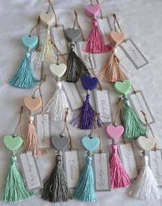 a bunch of tassels that are on a white sheet with some tags attached to them