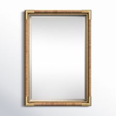 a gold framed mirror hanging on the wall