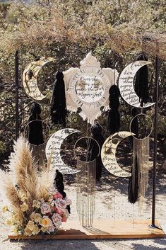 an artistic display in the desert with moon and stars on it, surrounded by dried grass