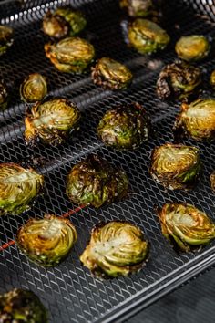 the brussel sprouts are being cooked on the grill