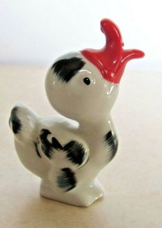 a white and black bird figurine sitting on top of a table