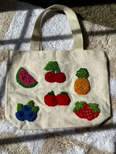 a white bag with fruits and vegetables on it