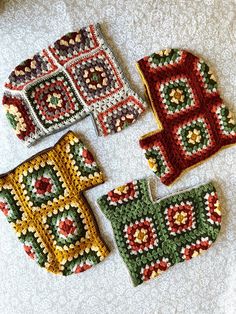 four crocheted items are laid out on the floor next to eachother