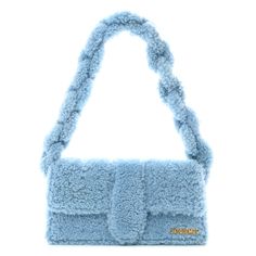 This is an authentic JACQUEMUS Shearling Le Bambidou in Light Blue. This bag is finely crafted in blue shearling fur. It features a braided shearling shoulder strap and opens to a beige fabric interior with a patch pocket. Beige Fabric, Patch Pocket, Calf Skin, Dark Green, Light Pink, Dust Bag, Shoulder Strap, Light Blue, Turquoise