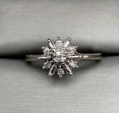 This gorgeous ring features a starburst design of genuine, natural, sparkling diamonds crafted in 10k white gold.  We estimate the diamonds to be .17 total carat weight with H color and I2 clarity.  Size = 7  Weight = .09 oz. or 2.9 grams   IMPORTANT NOTICE:  If you would like to inquire about re-sizing, please message us and wait for a response before you finalize your purchase.  If the re-sizing is possible we then add the re-sizing fee to your total before you finalize your purchase.  We do n Starburst Diamond Ring, Starburst Ring, Starburst Design, Gorgeous Ring, Sparkle Diamonds, Rings Statement, Statement Rings, Diamond Ring, Jewelry Rings