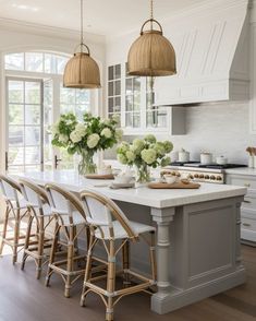 a large kitchen island with chairs around it