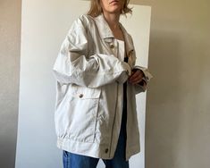 Vintage menswear bomber jacket with flap pockets. Zipper and button closure, lined. ✏️ TAGS WORLD HIT on buttons 65% cotton 35% polyamid lining 100% polyester ✂️ CONDITION  good vintage condition,  steamed and ready to wear. 📏 MEASUREMENTS  measured laying flat, please double for circumference: length 28" 71cm shoulders  23 1/4" 59cm bust 29" 74cm sleeve 24 1/2" 62cm  📌 PLEASE NOTE  If you're in doubt, please ask for more measurements or information. Although we try our best to reflect colors accurately, there might be slight differences in their appearance on your screen. Model is 5'6"/170cm tall with measurements 31-26-35 inches (79-66-89 cm) and wears size S All bemydear garments are pre-owned and may display minor signs of wear and age, but any notable flaws will be mentioned in desc Oversized Collared Outerwear With Multiple Pockets, Oversized Collared Outerwear With Side Pockets, Cotton Windbreaker With Pockets For Work, Cotton Workwear Windbreaker With Pockets, Oversized Windbreaker With Pockets For Work, Vintage Spring Outerwear With Multiple Pockets, Everyday Windbreaker With Pockets, Fall Button-up Windbreaker With Pockets, Everyday Long Sleeve Windbreaker With Pockets