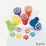 dog paw stampers are shown on top of a piece of paper with colored ink