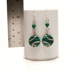 These handmade wire wrapped malachite arrings unique piece you are holding was made by hand especially for you... These silver earrings are simply stunning and perfect for livening up an everyday outfit. I can offer matching necklace and bracelet. My other pieces here: https://www.etsy.com/shop/BeyhanAkman My malachite arrings is coated with a durable clear non-toxic polymer to prevent tarnishing and oxidation formation. You'll receive this in a lovely gift wrapped box. I can include a handwritt Green Wire Wrapped Metal Earrings, Hand Wrapped Wire Earrings For Gift, Green Wire Wrapped Silver-plated Jewelry, Hand Wrapped Metal Earrings As Gift, Round Hand Wrapped Earrings For Gifts, Hand Wrapped Earrings For Gifts, Hand Wrapped Round Earrings For Gift, Green Wire Wrapped Round Earrings, Green Wire Wrapped Earrings For Gift