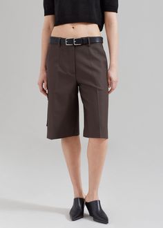 Color: Brown Lightweight fluid fabric Relaxed fit Rests low on the waist Front pleat detailing Belt loops Side seam pockets Cargo pocket detailing Illusion welt back pockets Hook and bar closure Zip fly Unlined 100% Polyester Dry Clean Imported Cargo Shorts, Relaxed Fit, Color