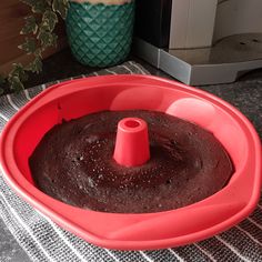 a red cake pan sitting on top of a table