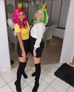 two women dressed in costumes standing next to each other