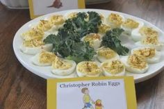 an egg tray with hard boiled eggs and greens on it next to a children's book