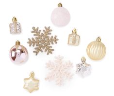 various christmas ornaments are arranged on a white surface with snowflakes and baubles