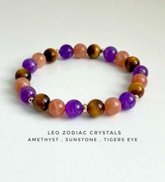 a bracelet with purple, orange and brown beads on white background text reads leo zodiac crystals amethyst sunstone tigers eye