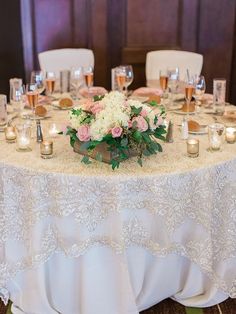 a table is set with candles and flowers for a wedding reception at the inn on main street